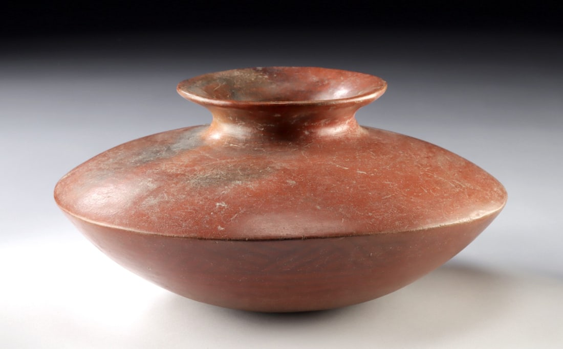 Large Colima Carinated Redware Vessel for Shaft Tomb: Pre-Columbian, West Mexico, Colima, ca. 300 BCE to 300 CE. A broad redware pottery vessel with a sharply carinated profile, giving the form a low, flattened silhouette and wide, flaring neck. The smoo