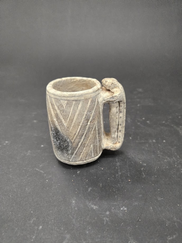 Anasazi Black-on-White Lizard Cup, TL Tested: Native American, Ancestral Puebloan (Anasazi), ca. 1050–1300 CE. A cylindrical earthenware mug from the Ancestral Puebloan world, its pale slipped body wrapped in crisp diagonal bands of black m