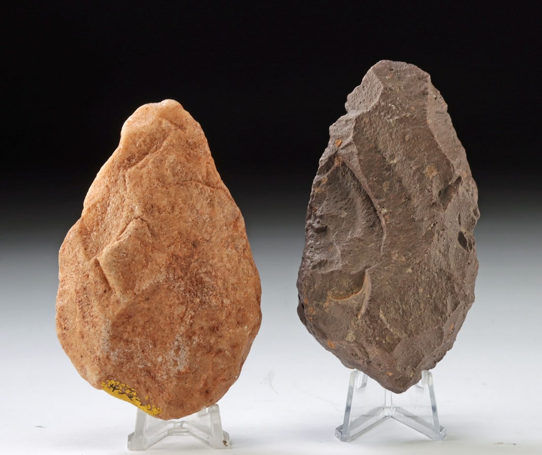 Two Native American Archaic Stone Hand Axes: Native American, Archaic Period, ca. 8000 to 1000 BCE. A pair of Native American stone hand axes, each shaped through direct percussion flaking to produce functional cutting edges and graspable forms.