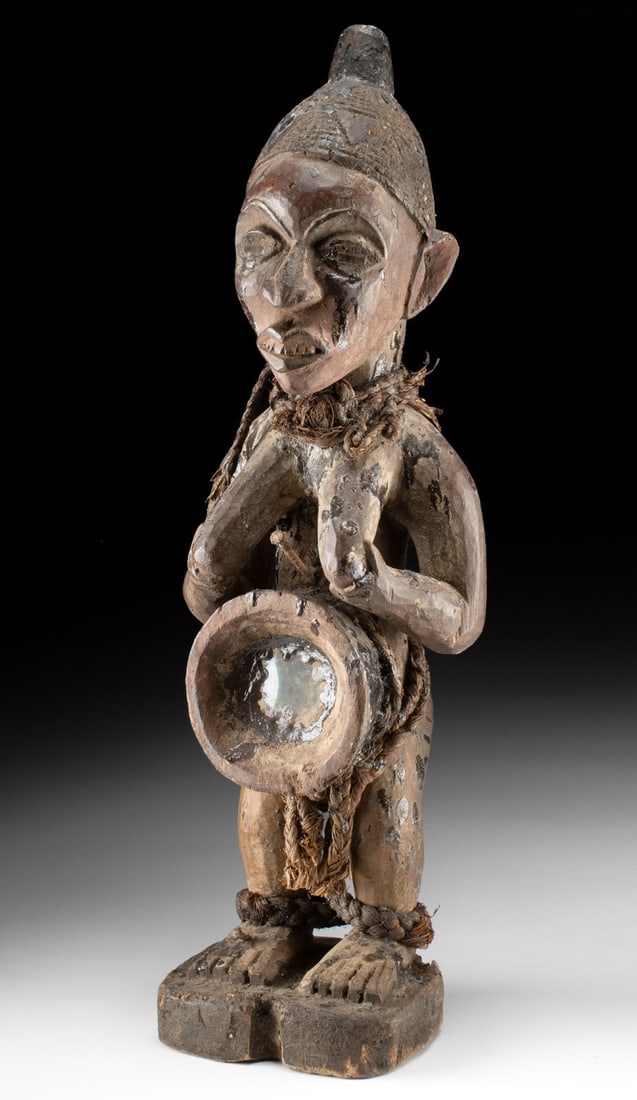 Yombe Wood Nkisi Nkondi Figure - Glass Inset: Central Africa, Kongo, Yombe people, ca. mid-20th century CE. A vigilant and forceful presence, this Yombe nkisi nkondi figure stands as both guardian and instrument of spiritual authority, its surfac