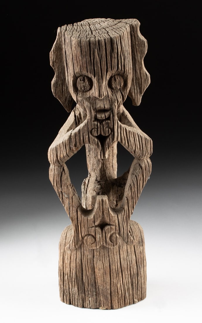 Borneo Dayak Wood Ancestral Figure, Hampatong Guardian: Southeast Asia, Indonesia, Borneo, Dayak peoples, ca. 19th to early 20th century CE. A weathered wooden post carved with a Hampatong figure, an ancestral and protective guardian spirit, shown seated a