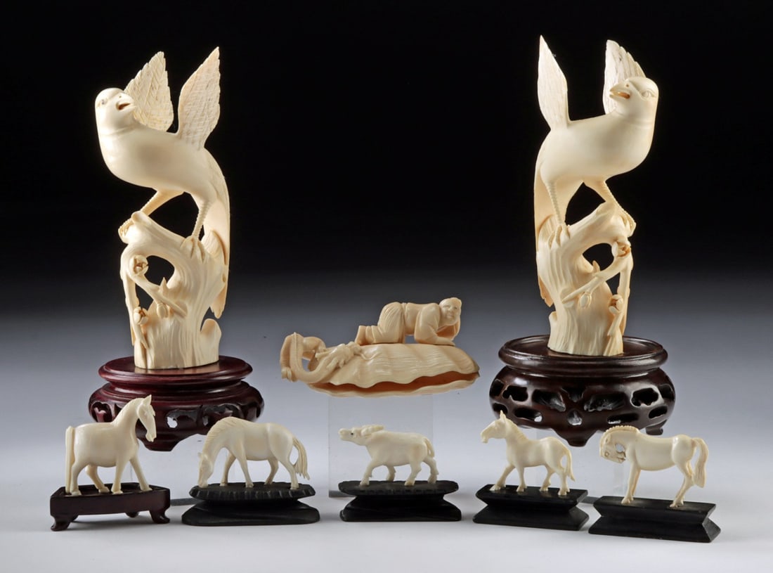 8 Chinese Ivory Statues: Phoenix, Horses & Shen Dragon: East Asia, China, ca. mid to late 20th century CE. A collection of carved elephant ivory figural sculptures, comprising a matched pair of large birds, likely phoenixes, perched atop branches, and moun