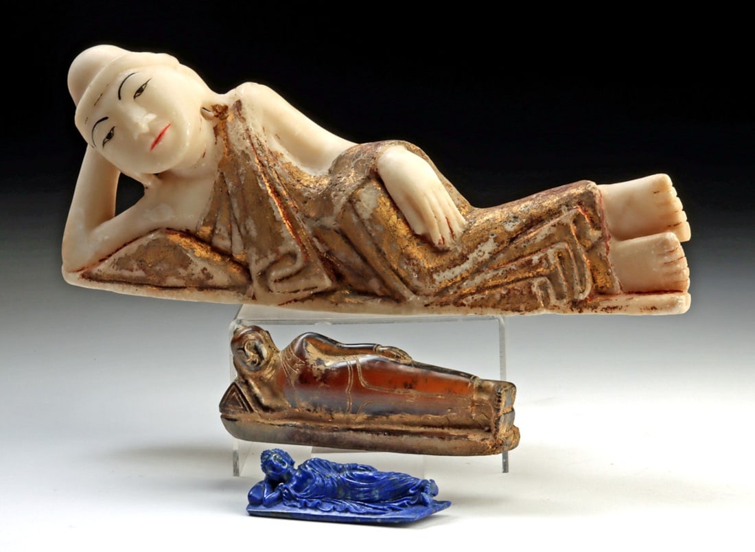 Burmese Reclining Buddhas - Marble, Glass, Lapis Lazuli: Southeast Asia, Burma (Myanmar), ca. 19th and middle of 20th century CE. Comprising a group of three reclining Buddha images, including: a carved white marble figure with painted facial features and t