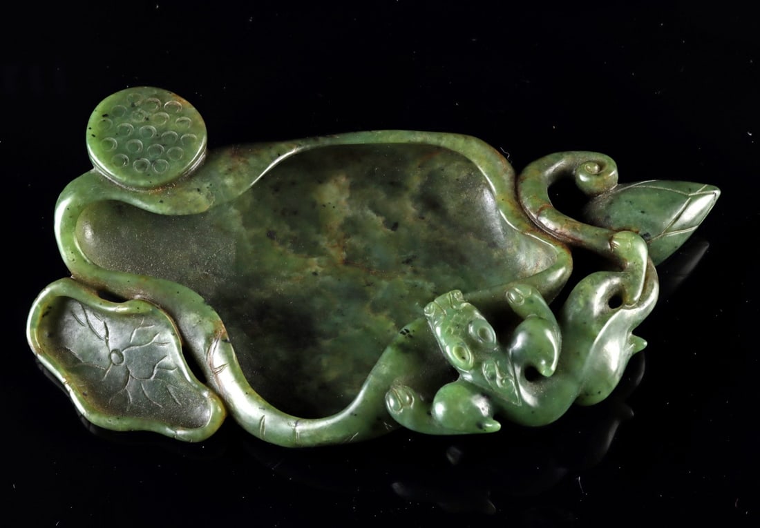 19th C. Qing Spinach Jade Brush Washer - Lotus Pod, Leaves and Chilong: East Asia, China, Qing Dynasty, ca. 1800–1899 CE. A scholar's brush washer carved from a single block of deep spinach-green nephrite, its mottled olive tone shot through with russet veining. The