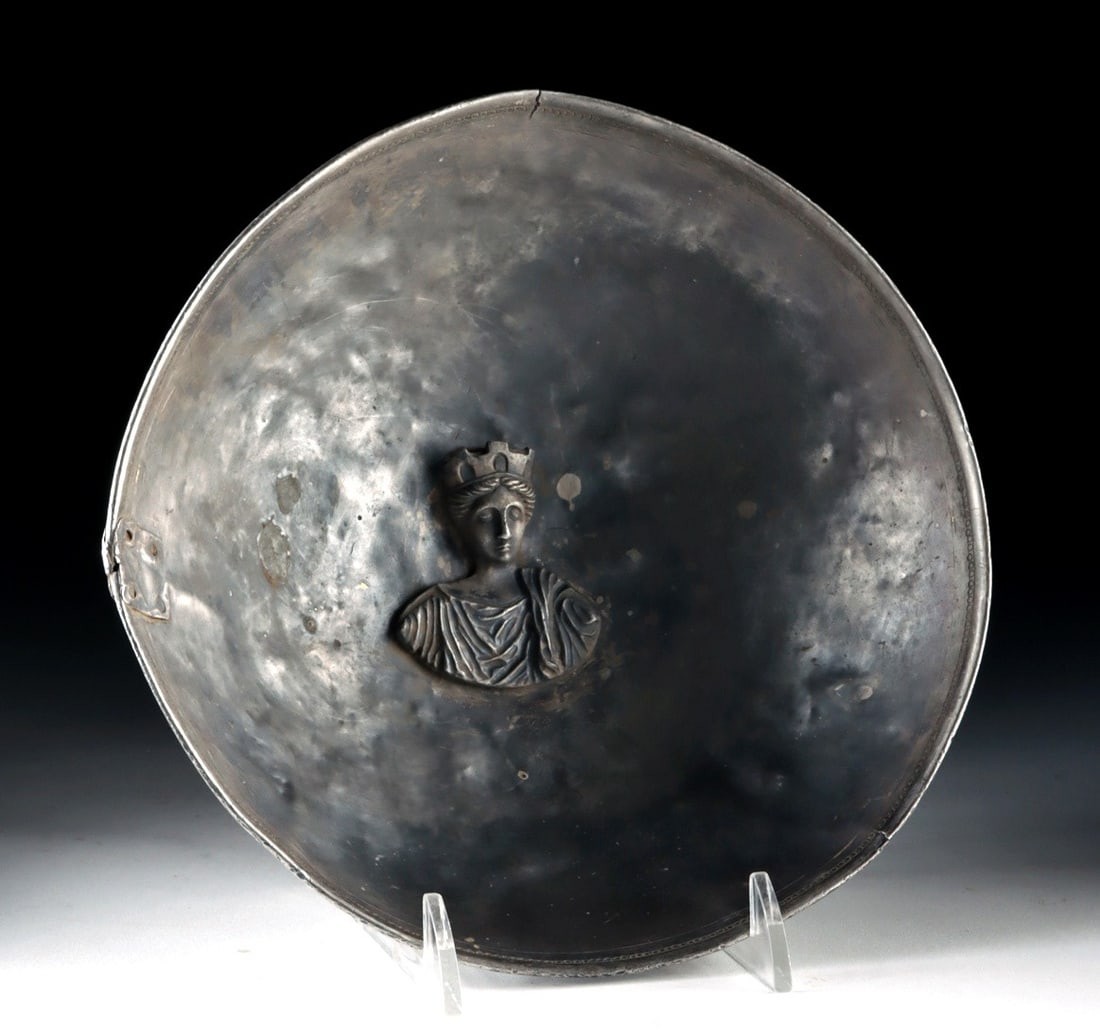 Roman Silver Phiale Fortuna / Cybele Bust in Tondo: Roman, Imperial period, ca. 1st to 3rd century CE. A refined Roman silver phiale centered by a repoussé bust of a mural crowned goddess, identified as either Fortuna or Cybele, both powerful embo