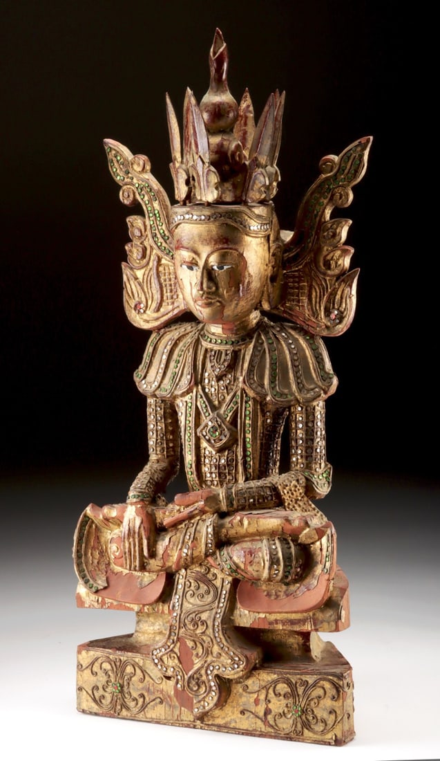 Large 19th C. Burmese Coppered Wood Crowned Buddha: Southeast Asia, Burma (Myanmar), ca. 19th century CE. A serene and commanding crowned Buddha carved from wood and richly coppered, seated in bhumisparsa mudra ("earth-touching gesture"), his right han