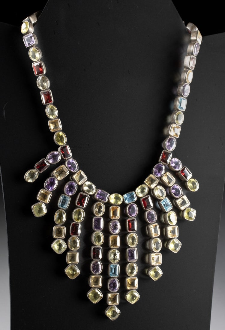 Silver & Semi-Precious Stone Bib Statement Necklace: United States, ca. mid to late 20th century CE. A statement bib necklace featuring a series of form-fitting silver bezels set with semi-precious stones. Each bezel is linked to the next by a ring, pro