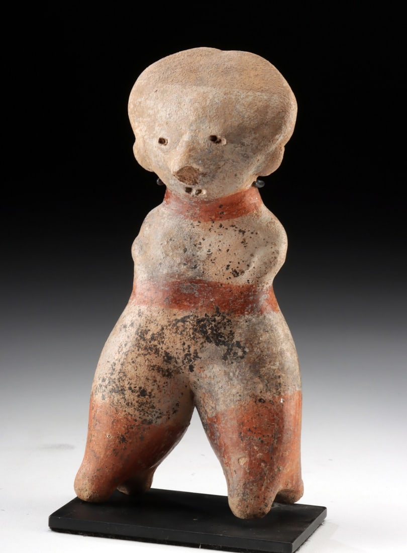 Nayarit Chinesco Pottery Standing Shaft Tomb Figure: Pre-Columbian, West Mexico, Nayarit, ca. 300 BCE to 300 CE. A Chinesco pottery standing figure, modeled with broad legs and a bulbous head, its facial features rendered with small impressed eyes, mout