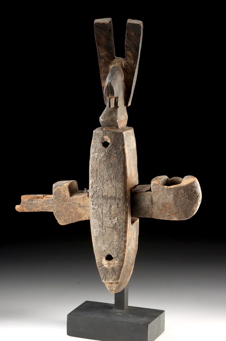 Early 20th C. Bamana Wood Figural Granary Door Lock: West Africa, Mali, Bamana/Malinke peoples, ca. early to mid-20th century CE. A hand-carved wooden door lock of an anthropomorphic form with a horizontal slide bar inserted through the central body cav