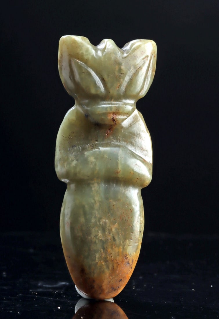 Chinese Nephrite Jade Zoomorph Pendant: China, Qing to Republic, late 19th to mid 20th century CE. A carved nephrite jade pendant in the form of a stylized mythical creature, worked in pale celadon-green stone with natural mottling and area