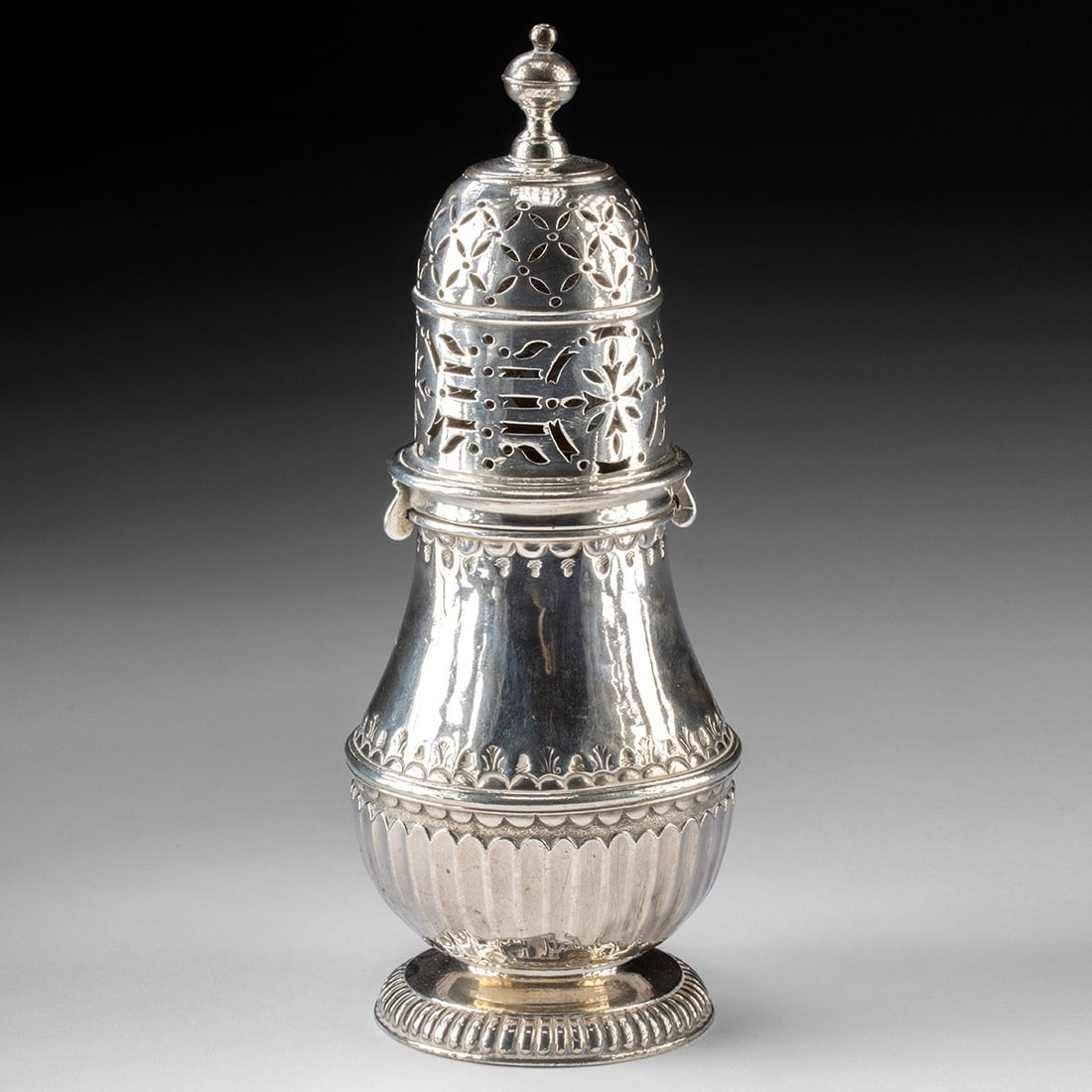 Hallmarked Early 18th C. English Silver Muffineer by Robert Keble: Western Europe, England, Queen Anne period, ca. 1712 CE. A Queen Anne Britannia standard silver caster by Robert Keble, London, hallmarked 1711. The pear-shaped baluster body is worked with spiral gad