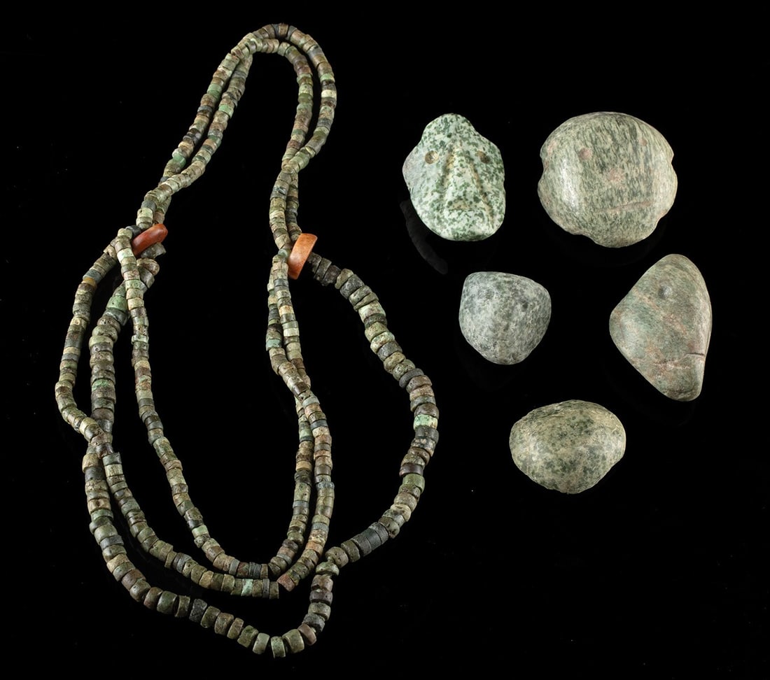 Mezcala Greenstone Bead Necklace + Five Face Pendants: Pre-Columbian, Southern Mexico, Guerrero region, Mezcala to early Maya culture, ca. 600 BCE to 100 BCE. A greenstone bead necklace accompanied by five carved face pendants. The necklace is strung in m