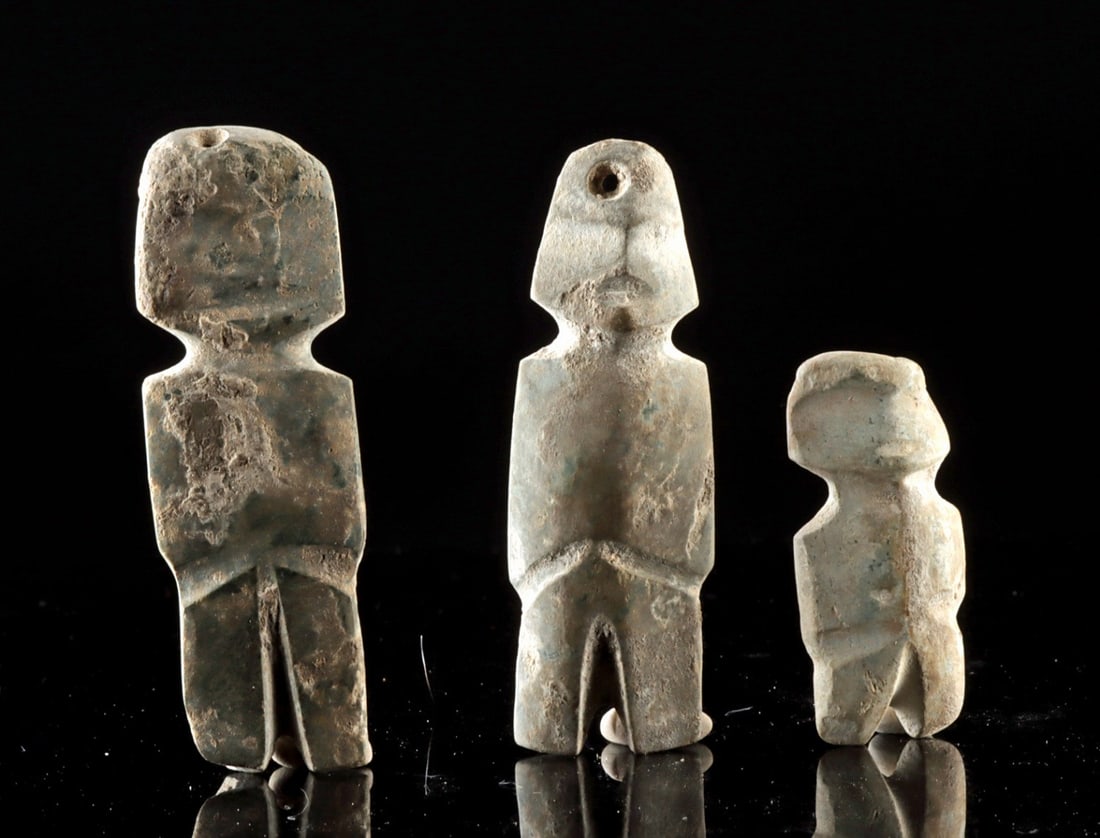 Three Guerrero Mezcala Pendant Sized Stone Axe Gods: Pre-Columbian, Mesoamerica, Guerrero region, Mezcala culture, ca. 300 BCE to 650 CE. A collection of three pendant-sized stone Mezcala anthropomorphic axe god figures carved in the region's abstract s