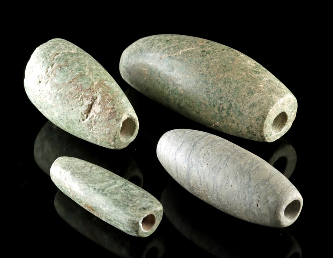 Four Massive Mezcala - Maya Greenstone Beads / Pendants: Pre-Columbian, Southern Mexico, Guerrero region, Mezcala to Maya culture, ca. 600 BCE to 900 CE. Four sizable hand carved greenstone beads in thick tubular forms. Green colored stones were prized for 