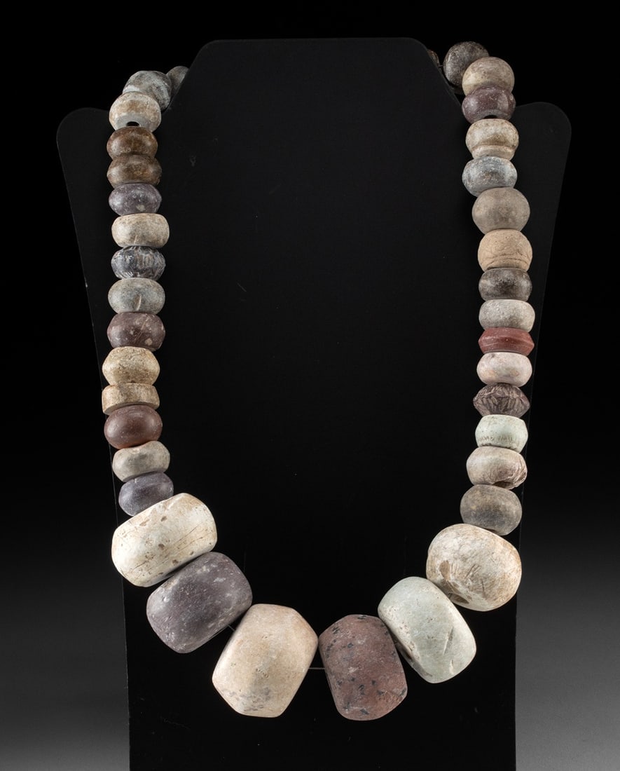 Mesoamerican Mezcala Massive Stone Bead Necklace: Pre-Columbian, Southern Mexico, Guerrero region, Mezcala to early Maya culture, ca. 600 BCE to 100 BCE. A collection of stone beads, including several of substantial size, pecked and polished in antiq