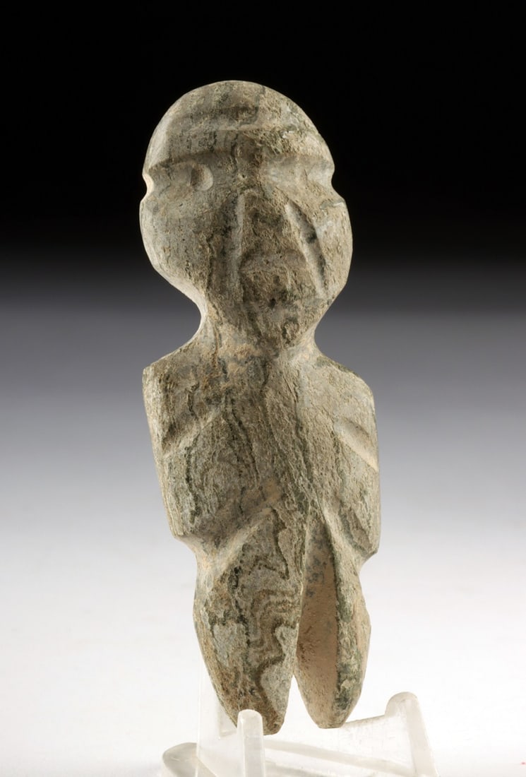 Guerrero Mezcala Stone Idol - Axe God Form: Pre-Columbian, Mexico, Guerrero, Mezcala culture, ca. 700 to 200 BCE. A finely carved stone axe god figure with a flattened, stylized form, broad head, and bifurcated legs, embodying the abstract, geo