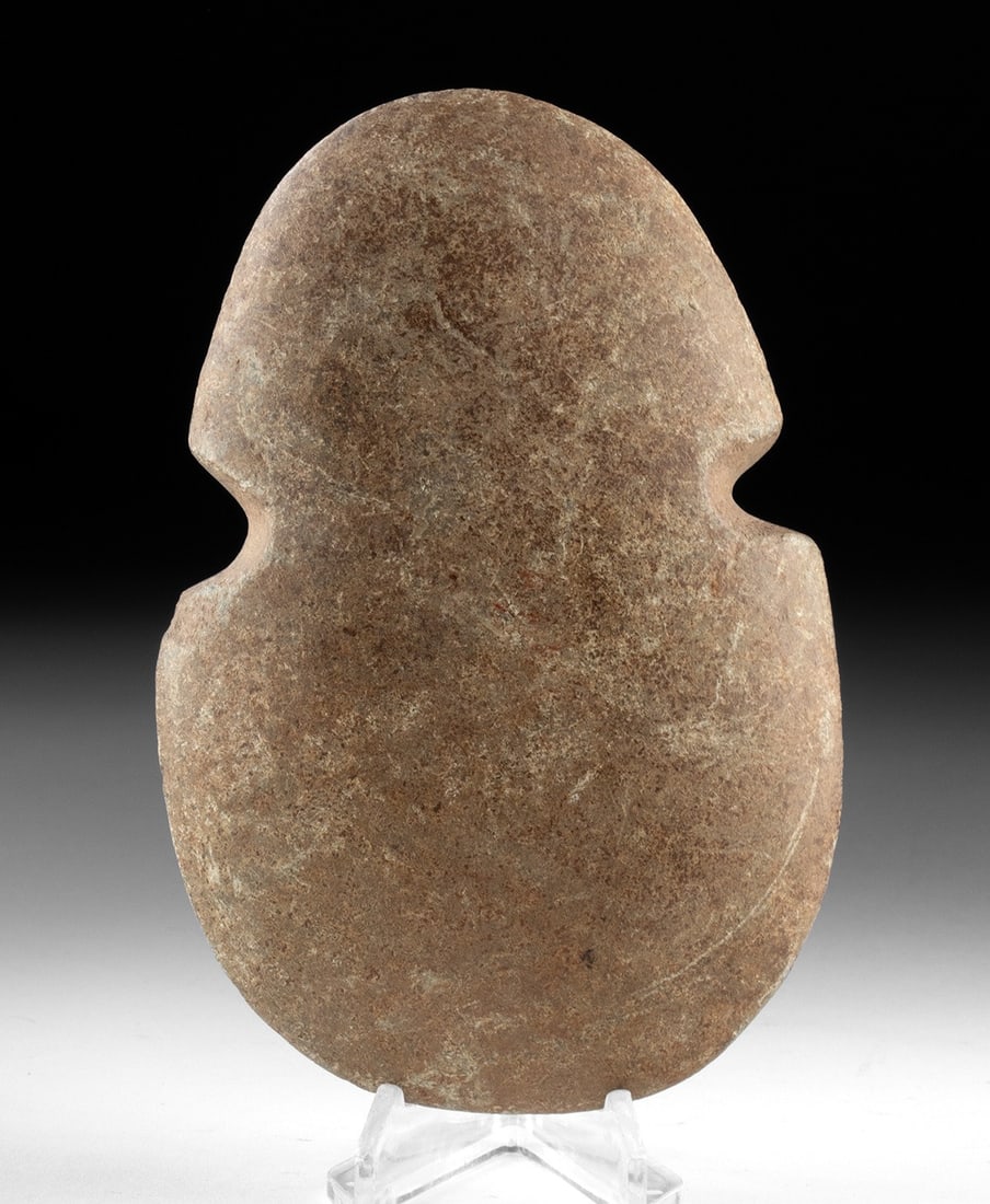 Jalisco Stone Axe Head: Pre-Columbian, West Mexico, Jalisco, ca. 300 BCE to 300 CE. A finely ground Jalisco stone axe head of broad, ovoid form, carefully shaped and polished to a smooth, tactile finish. The blade presents a