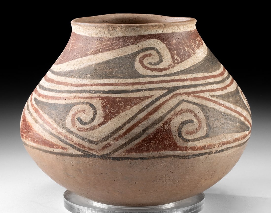 Casas Grandes Ramos Polychrome Pottery Jar: Pre-Columbian, Northern Mexico, Chihuahua region, Casas Grandes, Ramos Polychrome type, ca. 1200 to 1450 CE. A hand-built pottery jar of carinated form with a convex base and a flared rim. The beige-h