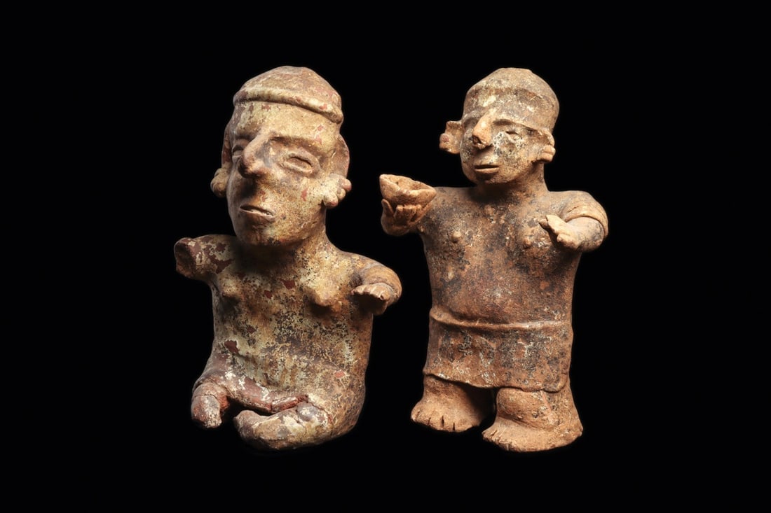 Nayarit Standing & Seated Figures (2): Nayarit, ca. 100 BCE – 250 CE. Two different pottery figures including a seated female depicted with a large head, wearing multi ring ear ornaments, simple nose ring and headband. Some