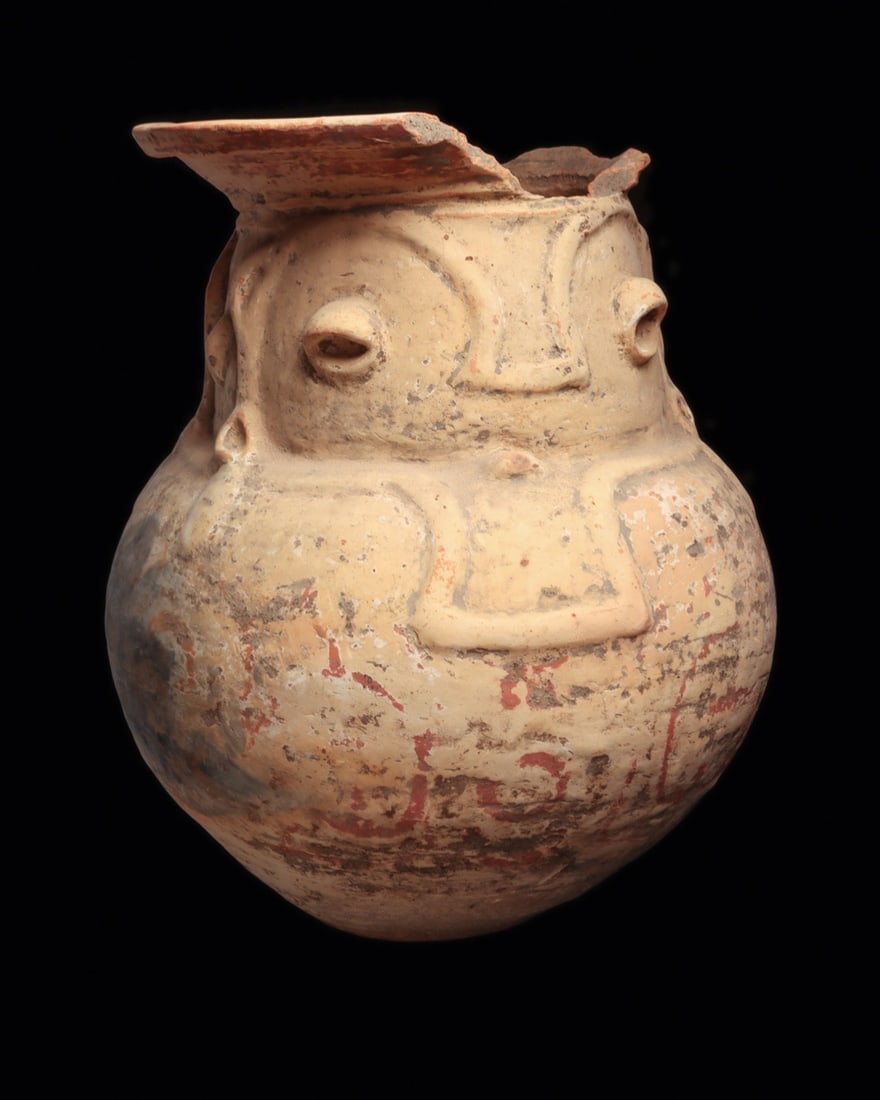 Medium-Large Marajoara Urn: Marajo Island, Para Brazil, ca. 1000 CE. Large heavy pottery anthropomorphic urn, having a bulbous body, janiform faces forming the neck and a wide flared rim. Some remaining traces of red and white