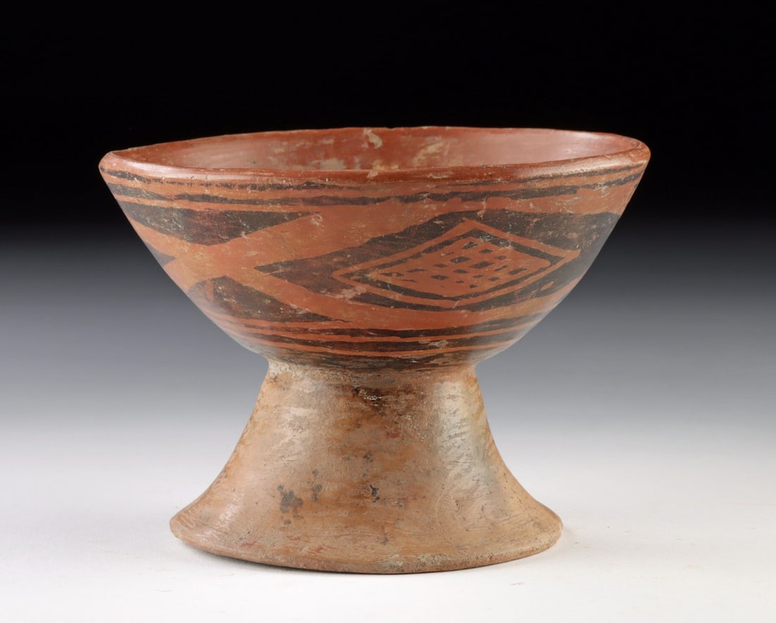 Narino Pottery Pedestal Cup w/ Negative Resist Motifs: Pre-Columbian, Colombia, Narino culture, ca. 9th to 15th century CE. A finely formed Narino pottery cup raised on a flaring pedestal foot, the wide bowl gently tapering outward from a narrow waist to