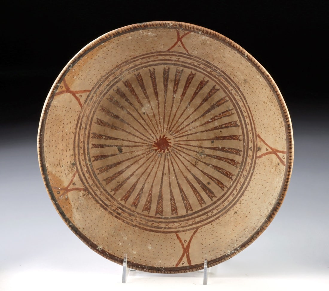 Narino Solar Wheel Bowl, Colombia: Pre-Columbian, Colombia, Narino culture, ca. 800 to 1250 CE. A large, shallow bowl with a bold solar or radial wheel motif on the interior: a dense burst of painted rays, alternating between solid