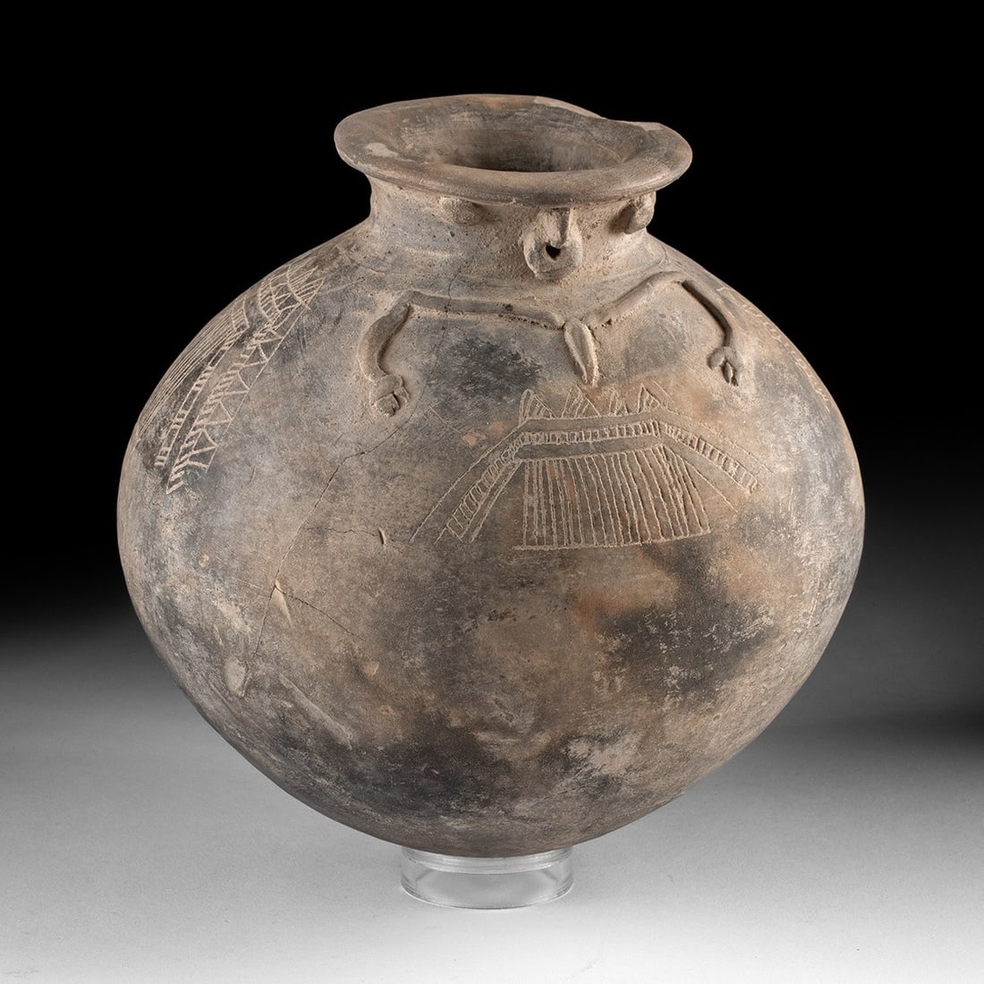 Carchi-Narino Incised Effigy Olla - Anthropomorphic Face: Pre-Columbian, Colombia/Ecuador, Carchi-Narino, ca. 800 to 1500 CE. A globular olla whose neck has been given a face and whose shoulders have been given arms, the vessel body thus becoming a torso: