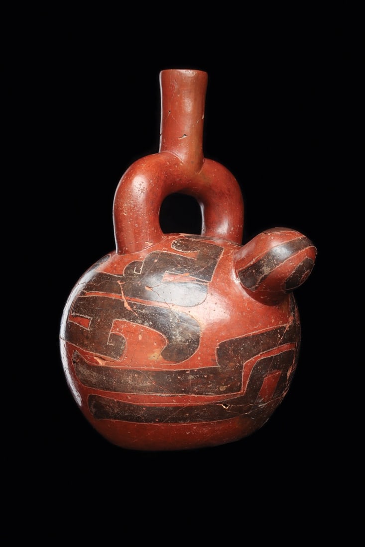 Chavin / Cayalti Decorated Stirrup Vessel: Cayalti culture / Chavin, ca. 800–500 BCE. Large pottery vessel having a stirrup type spout and large bulbous body with a projecting stylized bird head. Body is incised with semiabstract wings