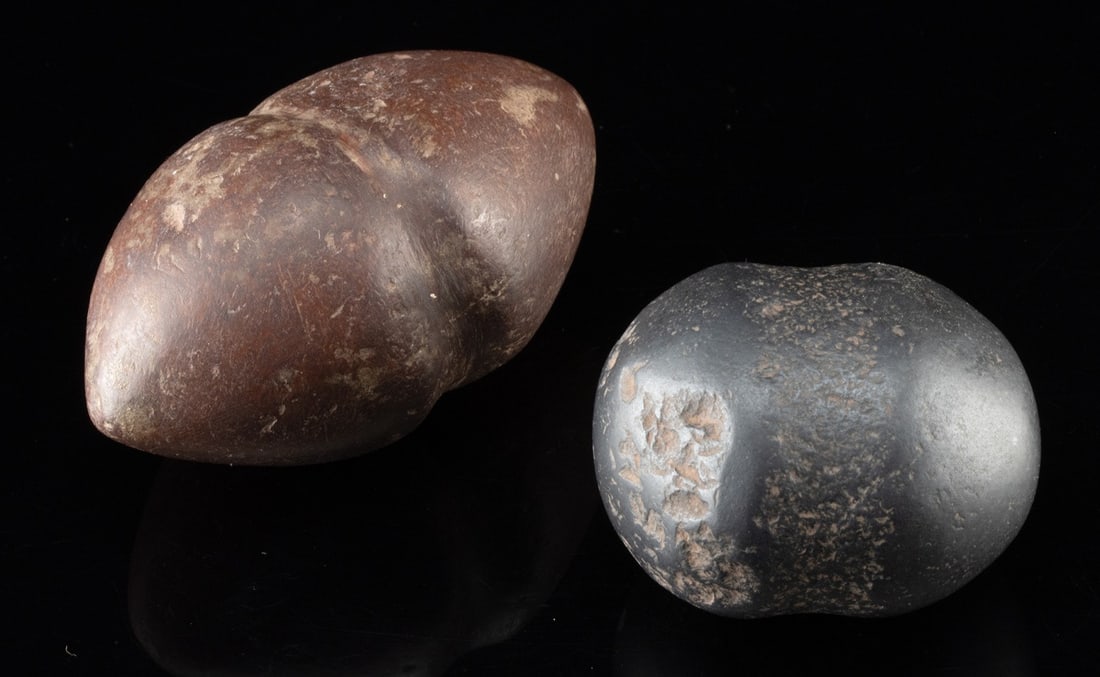 Two Grooved Stone Maul Heads | Pre-Columbian Peru and Plains Tribes: Pre-Columbian, Peru, Moche to Inca, ca. 500 to 1500 CE; Native American, United States, Plains Tribes, ca. 1500 to 1800s CE. A pair of stone club or maul hammer heads, one carved from hefty, magnetic 