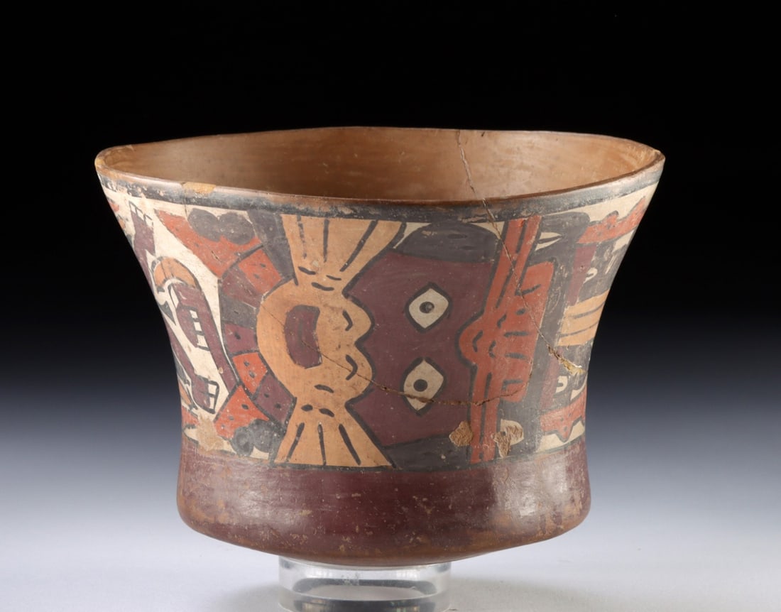 Nazca Polychrome Kero - Flying Anthropomorphic Mythical Beings: Pre-Columbian, Peru, Nazca, ca. 100–600 CE. A flaring beaker, or kero, of burnished earthenware, its exterior wrapped in a procession of two flying Anthropomorphic Mythical Beings rendered in th