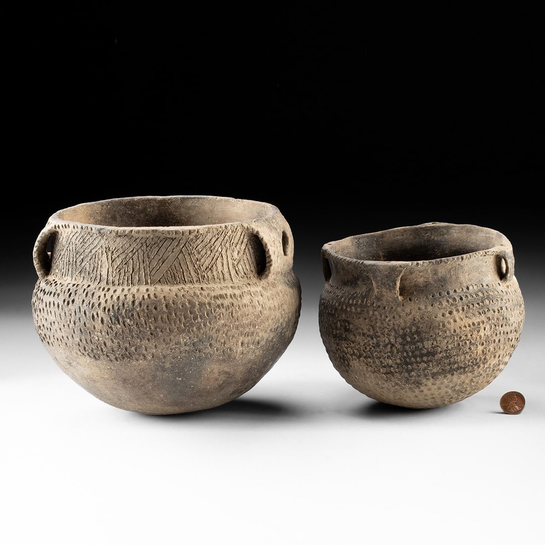 Mississippian Ranch Incised Vessels, Pair, Punctate Design: Prehistoric Native American , Texas or Arkansas, ca. 980–1320 CE. Native American, Mississippian culture, ca. 980 to 1320 CE. The larger vessel is of globular form with a constricted rim and opp