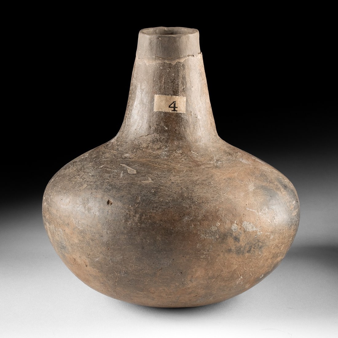 Mississippian Pottery Bottle - Bell Plain Long-Neck, Ex-Warhol: Native American, Southeastern / Midwestern United States, Mississippian culture, ca. 1200–1500 CE. A pottery Bell Plain long-neck bottle of globular form with a tall, slightly flared neck and sm