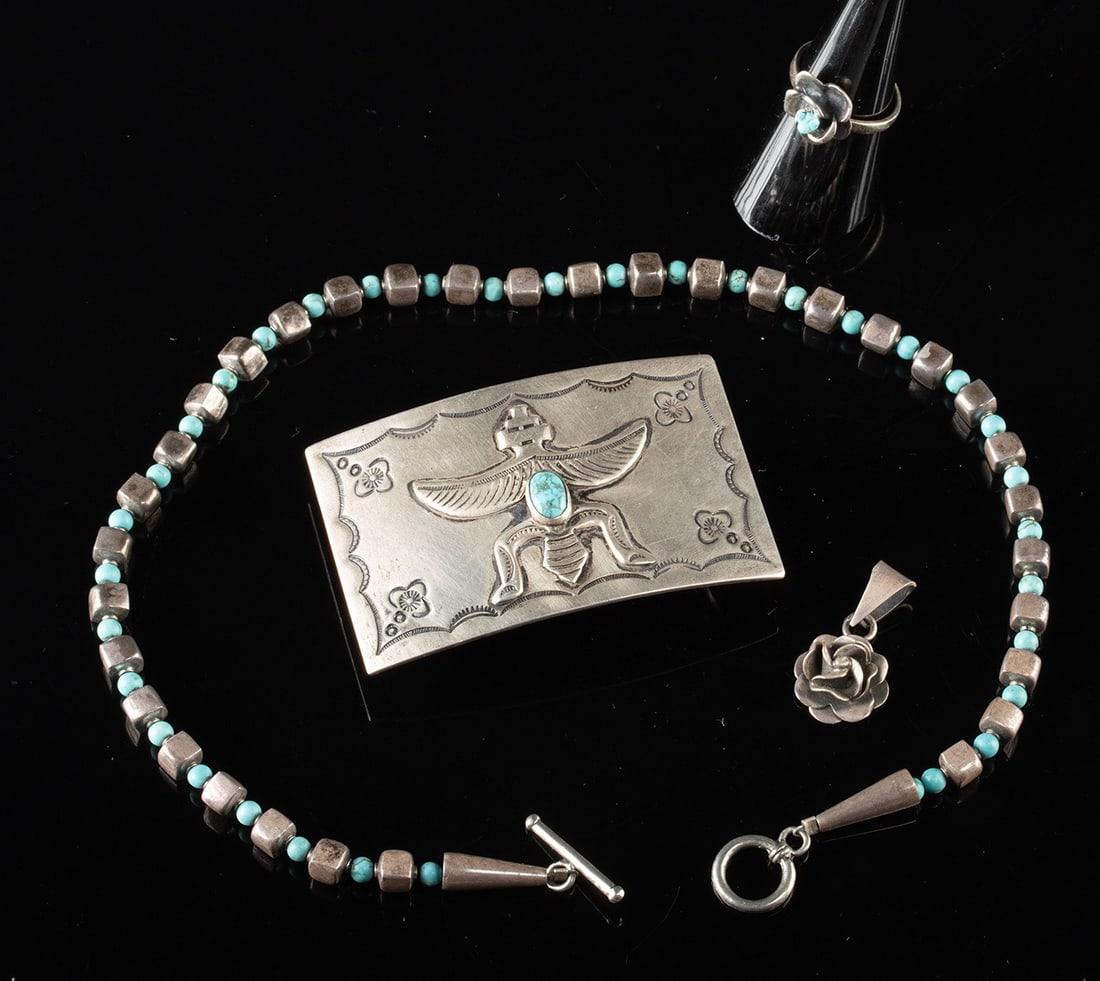 Mexican & Native American Silver & Turquoise Jewelry: Mexico and United States, ca. mid to late 20th century CE. A group of sterling silver accessories comprising a flower ring, a rose pendant, a beaded necklace, and a figural belt buckle. The ring is fo