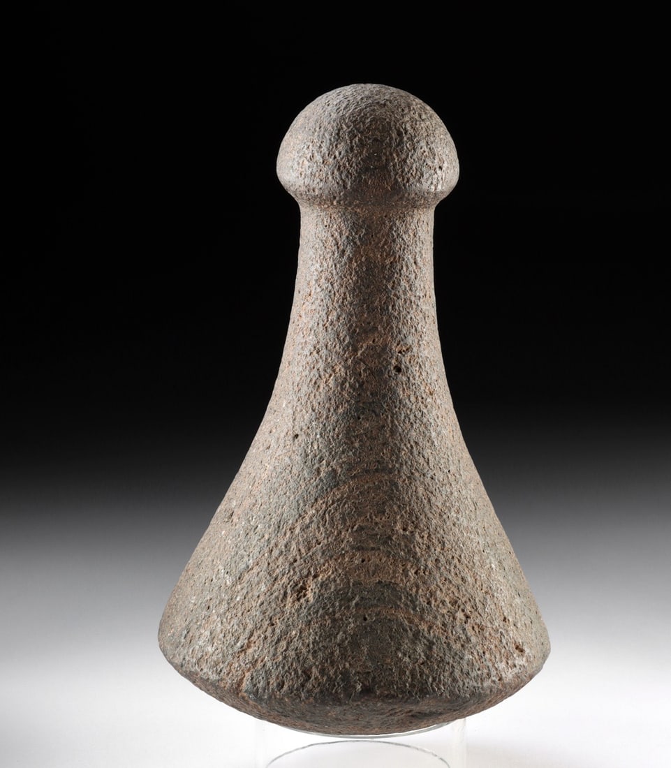 Traditional Hawaiian Stone Poi Pounder - Knob-Handled Basalt Tool: North Pacific, Hawaii, ca. 18th to 19th century CE. A substantial basalt poi pounder carved into the classic Hawaiian ring or knob form, its weathered volcanic surface worn smooth by generations of