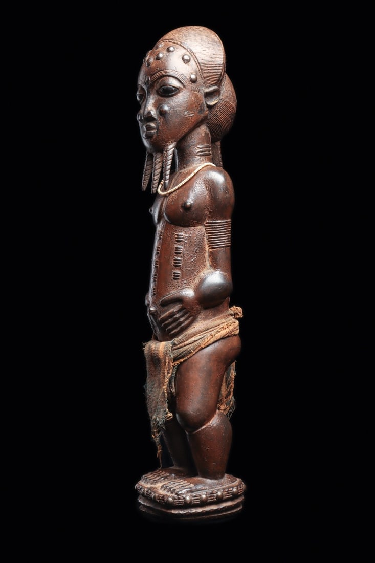 Baule Style Male Figure: Ivory Coast, mid 20th century. Decorative figure, well executed with rich details throughout, the figure features a beard divided into three sections, relief-carved scarification nodes on the cheeks, 