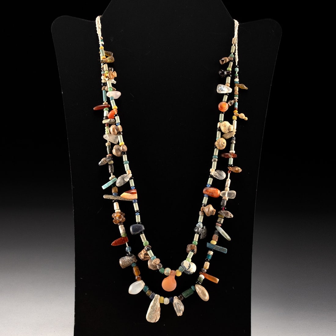 Roman Bead Necklace - Faience, Stone & Glass, Double Strand: Mediterranean, Levant and Roman, ca. 1550 BCE – 400 CE. A double-stranded necklace assembled from an array of ancient beads, their forms and hues gathered across centuries of Roman craft. Faienc