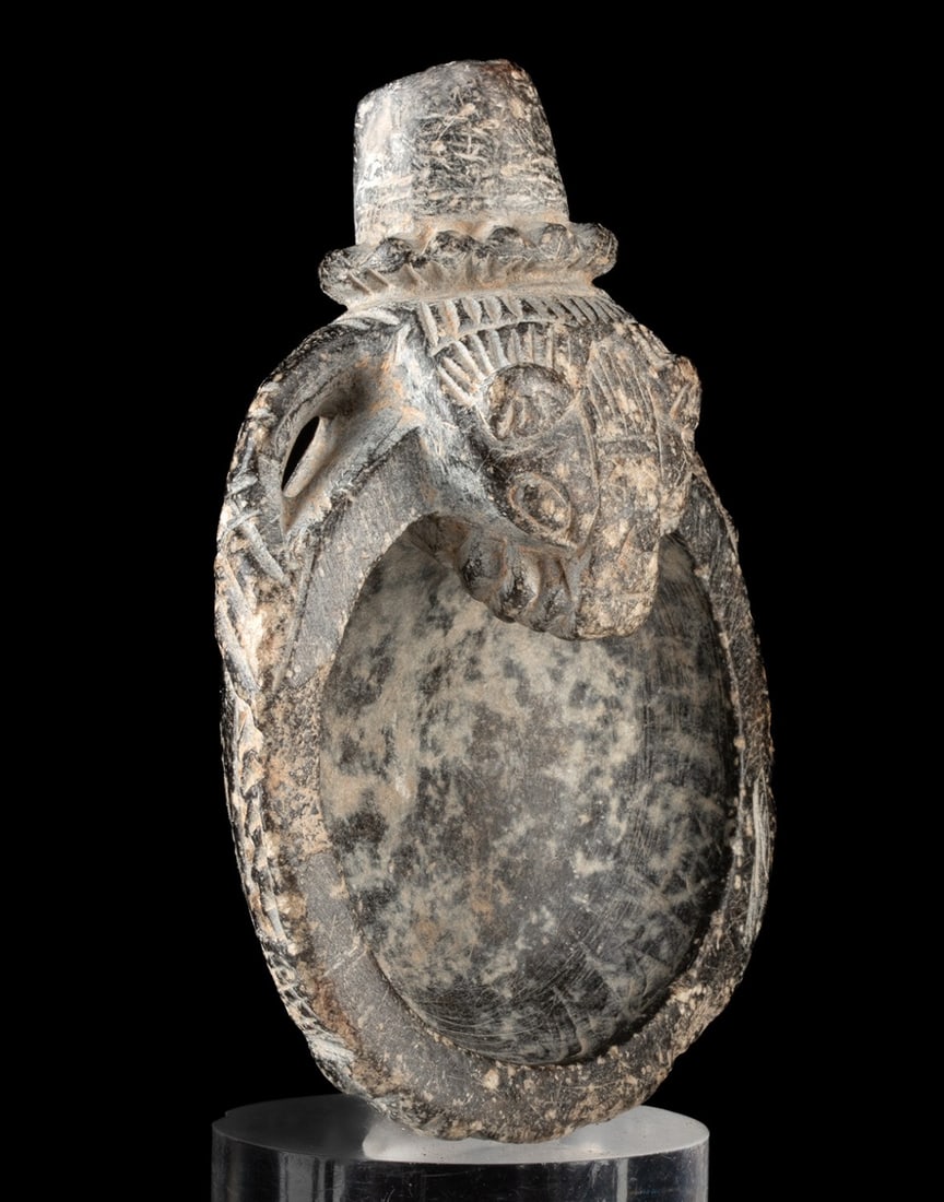 Neo-Assyrian Steatite Lion Libation Bowl, Iron Age: Near East, Levant / Mesopotamia region, Neo Assyrian Empire, Iron Age II, 9th to 8th century BCE. Carved from dark steatite, this sculptural libation or censer bowl is formed as a lion grasping the