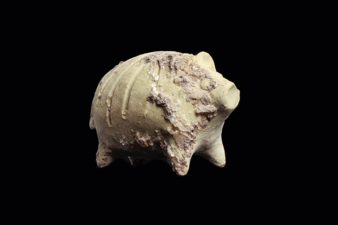 Mesopotamian Terracotta Boar: Ancient Near East, ca. 2nd millennium BCE. Hollow molded corpulent boar with round body on four raised feet. Head with long snout, twin pellet eyes, raised ears, incised mane and vent hole atop back. 