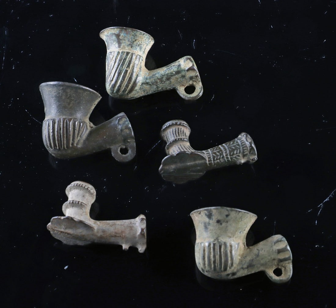 Ottoman Brass Pipe Bowls, Set of 5 | 16th-18th Century: Near East, Medieval period, Ottoman Empire, ca. 16th to 18th century CE. A fascinating group of five Ottoman pipe bowls cast in brass and leaded brass, each featuring a flaring bowl and short angled s