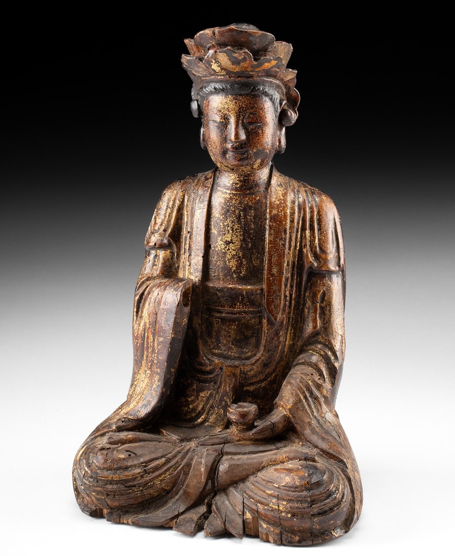 18th C. Chinese Qing Gilt Wood Statue of Guanyin: East Asia, China, Qing Dynasty, ca. 18th century CE. A serene wooden figure of the Bodhisattva Guanyin, retaining layers of lacquer and gilding across its surface. The figure is depicted in full lotus