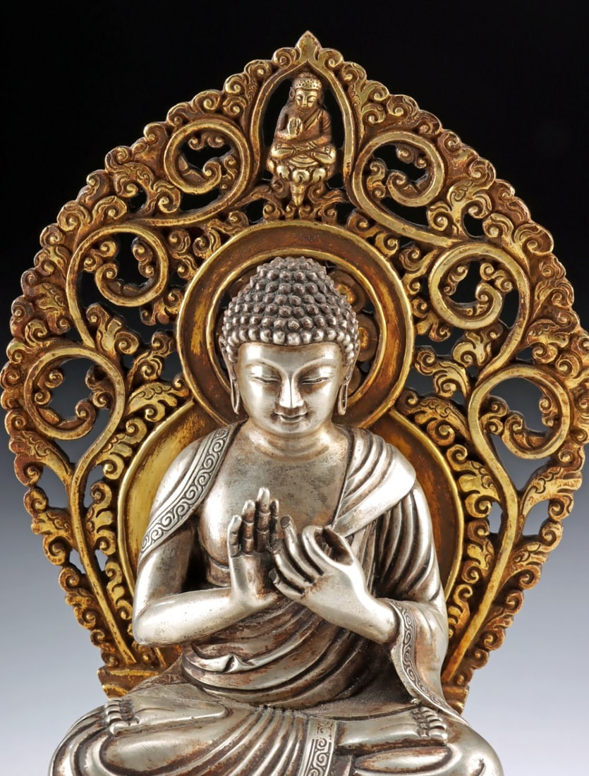 Gilt Copper & Silver Seated Buddha, Dharmachakra Mudra: East Asia, ca. late 20th to 21st century CE. A gilt copper and silver statue of a seated Buddha in the dhyanasana position, with hands forming the Dharmachakra mudra, a teaching gesture. The Buddha re