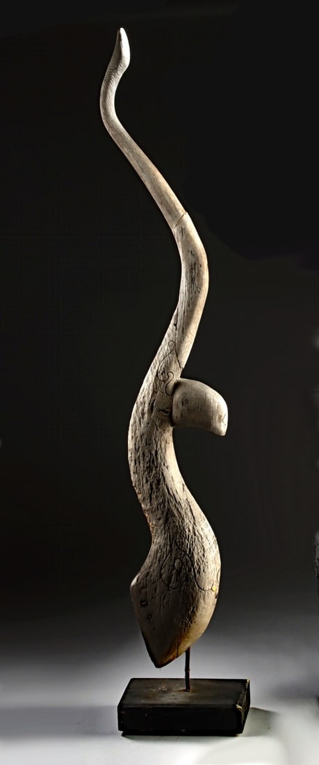 Early Thai / Lao Carved Wood Chofa, Temple Roof Finial: Southeast Asia, Thailand / Laos, ca. 18th to 19th century CE. A carved wooden chofa with a long rising curve that tapers to a pointed tip. The form flows upward from a thicker base, with a projecting 