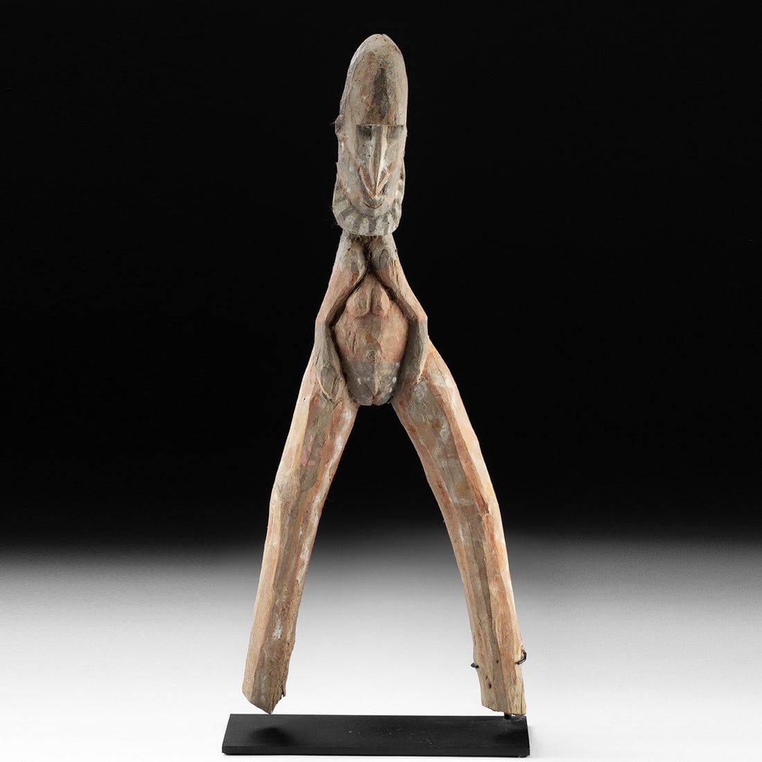 Papua New Guinea Abelam Female Initiation Figure - Tetepeku: Melanesia, Papua New Guinea, East Sepik Province, Abelam people, ca. 1950–2000 CE. A carved female figure whose long legs splay outward into a dramatic A-frame, hands drawn inward toward a promi
