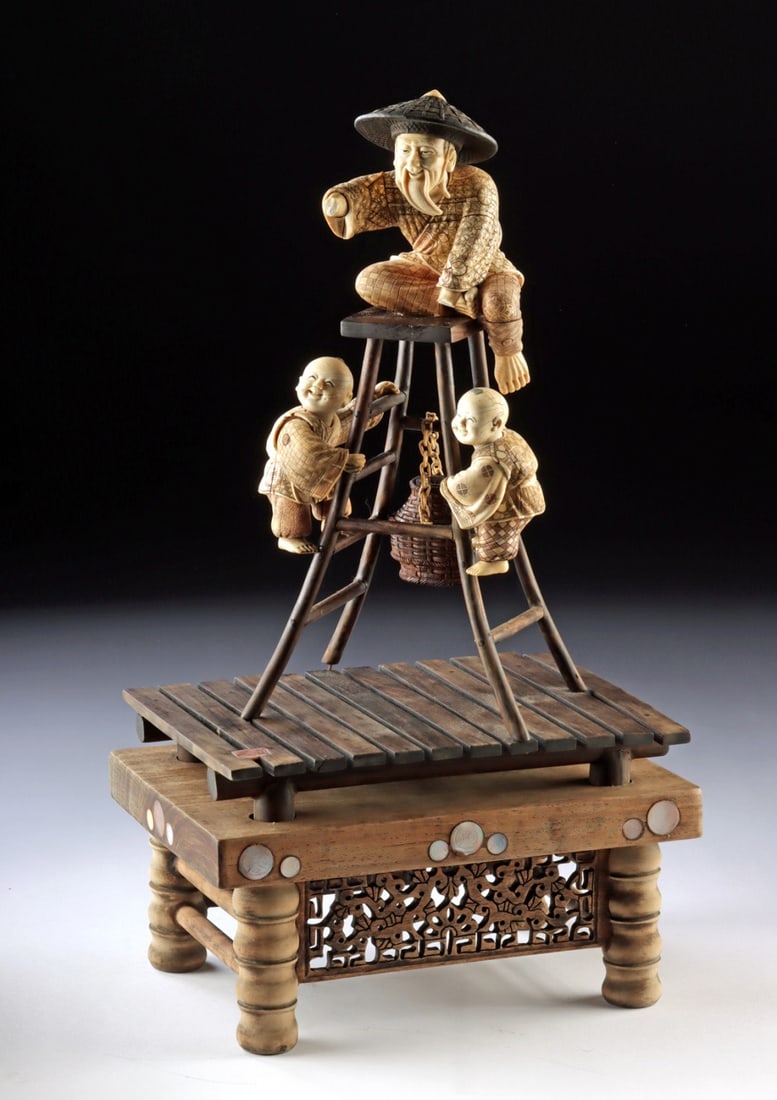 Japanese Mammoth Ivory Okimono Fisherman w/ Children: Tadamori (Japanese, active 20th to 21st century). Fisherman with children. Mammoth ivory and wood okimono carving. Signed in Japanese characters on inlay on base. A lively and finely composed okimono 