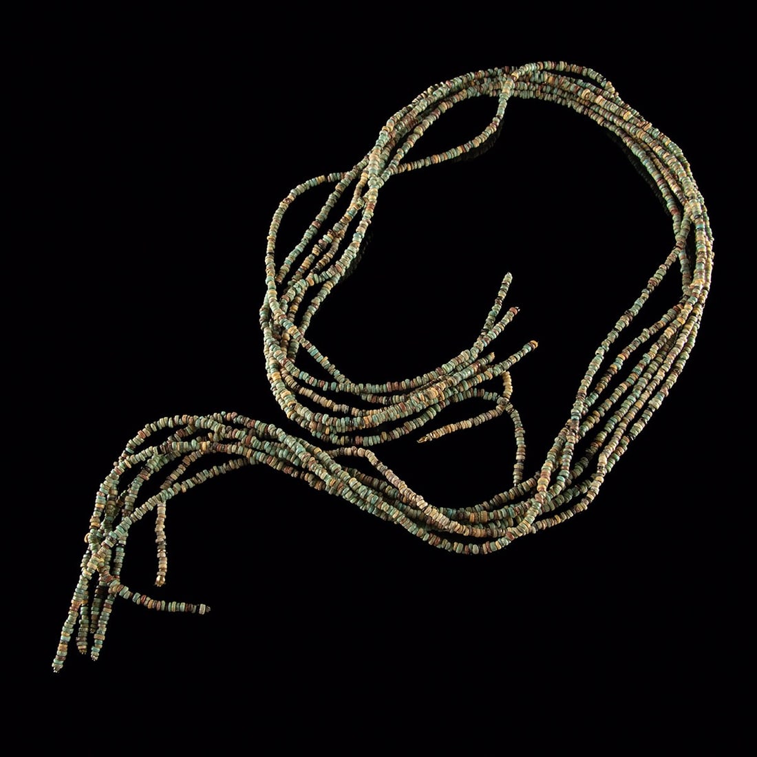 Egyptian Faience & Stone Bead Strands - Six Restrung Necklaces: North Africa, Egypt, Late Dynastic to Roman period, ca. 664 BCE – 395 CE. A cascade of six long strands threaded with hundreds of small disc beads in faience and stone, their surfaces weathered 