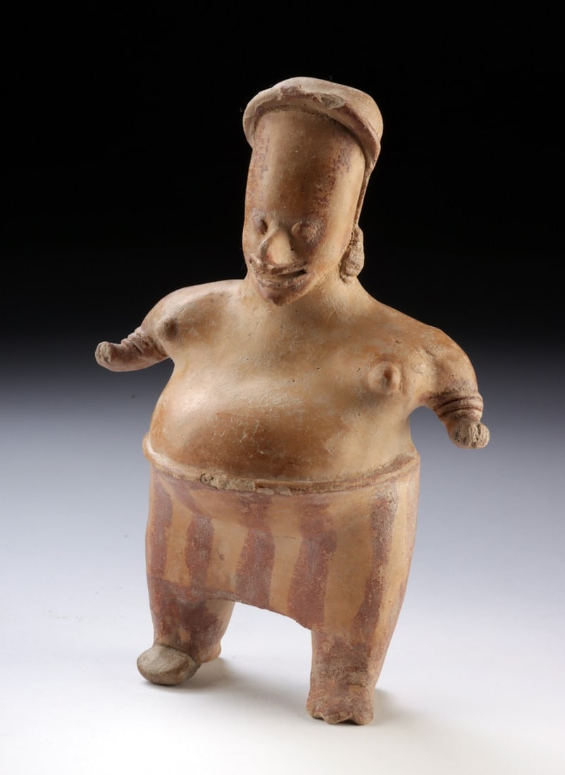 Jalisco Standing Pregnant Female Figure, Painted Skirt: Ca. 100 BCE - 250 CE. Pre-Columbian, West Mexico, Jalisco culture. A standing pregnant woman whose broad, planted stance carries an air of unshakeable physical authority - arms extended slightly from 