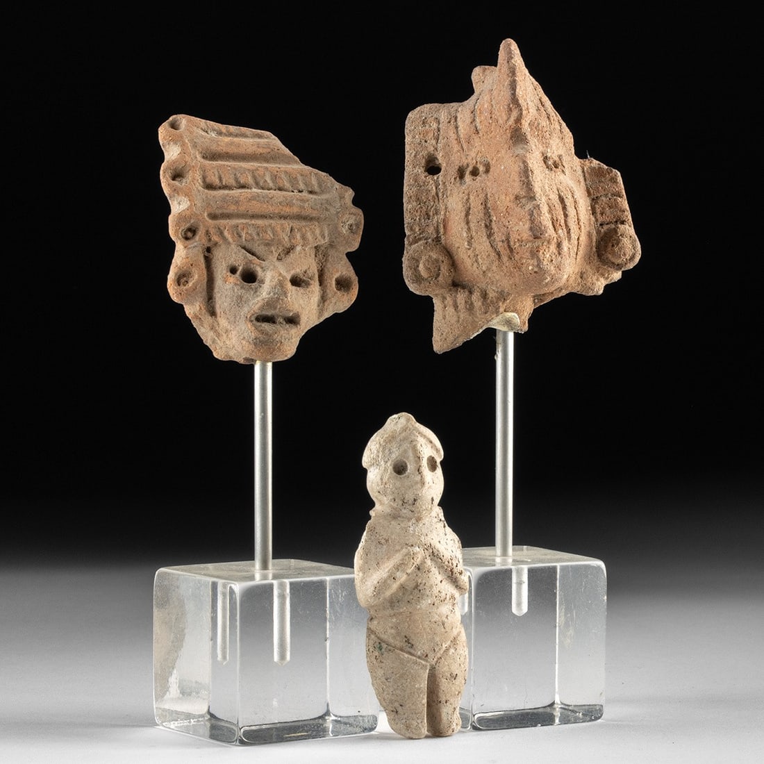 Veracruz & Michoacan Pottery Heads with Colima Stone Effigy Pendant: Pre-Columbian, West Mexico, Veracruz, Michoacan, and Colima cultures, ca. 300 BCE – 900 CE. A trio of diminutive figural fragments from three of ancient Mexico's most expressive ceramic and lapi
