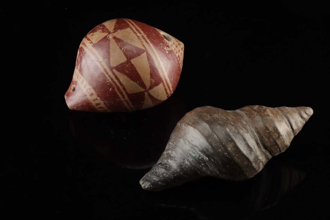 Narino & Colima Pottery Shell-Form Pendants - Ocarina: Pre-Columbian, Colombia and West Mexico, Narino and Colima, ca. 100 BCE – 600 CE. A pair of ceramic pendants modeled in the rounded, spiraling form of a gastropod shell, each pierced with suspen