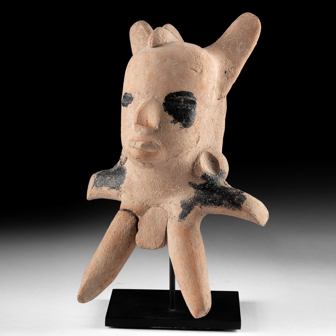 Veracruz Pottery Figure w/ Bitumen, TL Tested: Pre-Columbian, Mexico, Gulf Coast, Veracruz culture, ca. 15 BCE to 665 CE. A Classic-period Veracruz terracotta figure presents a serene human face mounted at the center of a body radiating six or mor