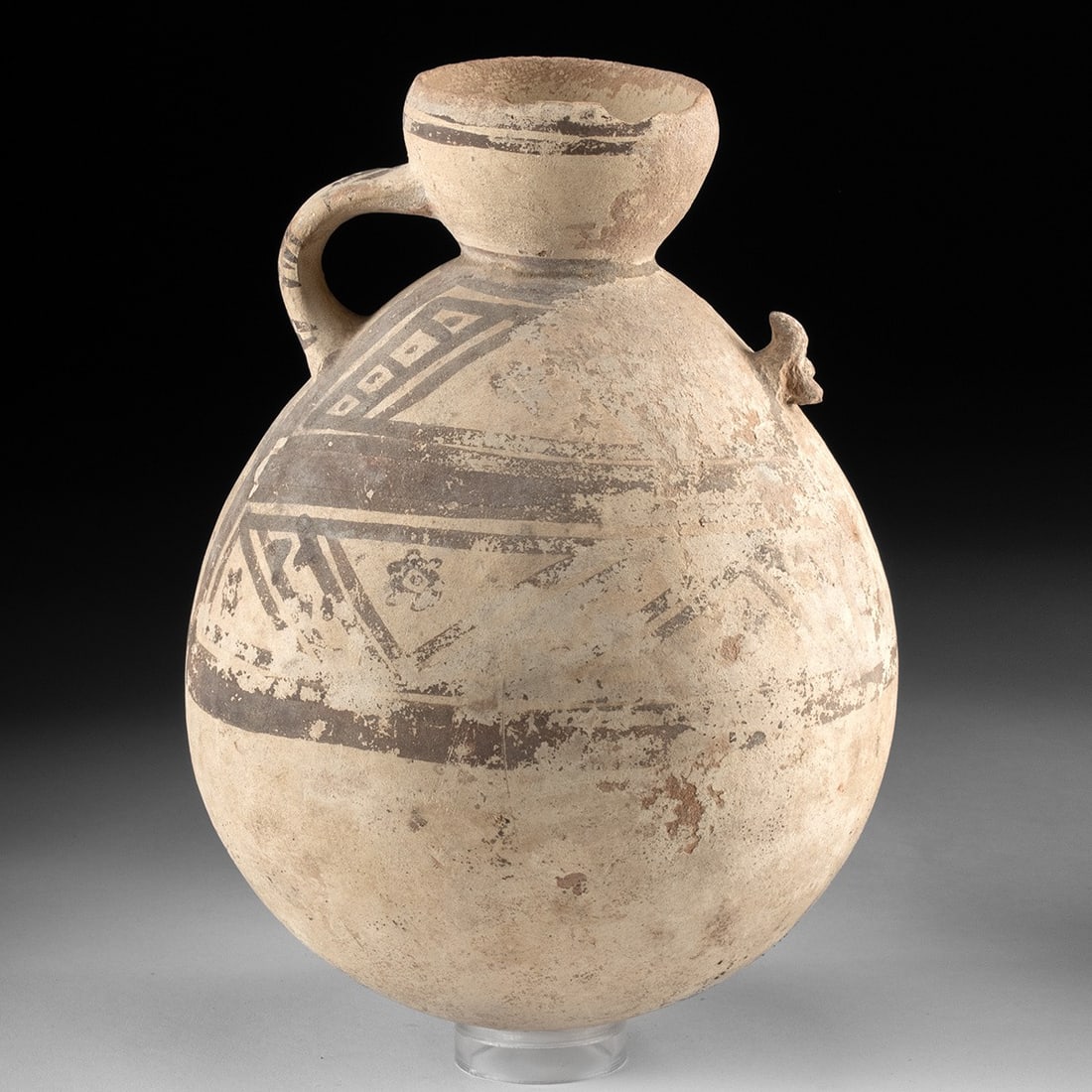 Pre-Columbian Chancay Bichrome Pottery Bottle with Geometric Motifs: Pre-Columbian, Peru, Chancay culture, ca. 1000–1470 CE. A large globular pottery bottle with a wide flaring neck and a single strap handle, the cream slip surface painted in dark brown with bold